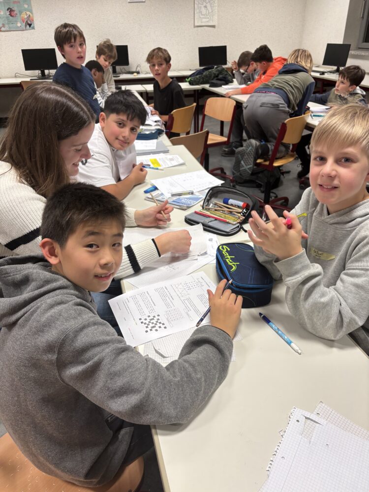 Schüler*innen, die in Kleingruppen schweirige Matheaufgaben lösen